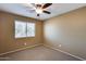 Bright bedroom with carpeted floor, ceiling fan, and window blinds at 24710 N 27Th Pl, Phoenix, AZ 85024