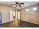 Bright bedroom featuring dark wood floors and access to a bathroom at 24710 N 27Th Pl, Phoenix, AZ 85024