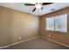 Bedroom with carpeted floor, ceiling fan, and window with blinds at 24710 N 27Th Pl, Phoenix, AZ 85024