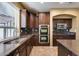 Kitchen boasts dark wood cabinets, granite counters, and double ovens at 24710 N 27Th Pl, Phoenix, AZ 85024