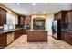 Spacious kitchen featuring an island and dark wood cabinetry at 24710 N 27Th Pl, Phoenix, AZ 85024