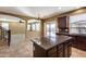 Open kitchen with island and view into living and dining areas at 24710 N 27Th Pl, Phoenix, AZ 85024