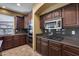 Spacious kitchen with dark wood cabinets, granite countertops, and stainless steel appliances at 24710 N 27Th Pl, Phoenix, AZ 85024