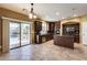 Eat-in kitchen with island, granite counters, dark wood cabinets, and sliding door to patio at 24710 N 27Th Pl, Phoenix, AZ 85024