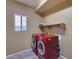 Convenient laundry room with red washer and dryer set at 24710 N 27Th Pl, Phoenix, AZ 85024