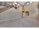 High ceiling living room with chandelier and staircase at 24710 N 27Th Pl, Phoenix, AZ 85024