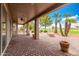 Covered patio with brick pavers, potted plants, and golf course view at 25037 S Ribbonwood Dr, Sun Lakes, AZ 85248