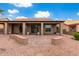 Backyard patio with covered area, brick pavers, and desert landscaping at 25037 S Ribbonwood Dr, Sun Lakes, AZ 85248