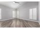 Bright bedroom featuring wood-look tile flooring and plantation shutters at 25037 S Ribbonwood Dr, Sun Lakes, AZ 85248