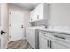 Laundry room with white cabinets, washer, dryer, and quartz countertop at 25037 S Ribbonwood Dr, Sun Lakes, AZ 85248