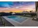 Relaxing backyard with a refreshing pool, comfortable seating, and stunning sunset views at 25422 S 228Th St, Queen Creek, AZ 85142