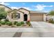 Single-story home with a two-car garage and well-manicured landscaping at 25422 S 228Th St, Queen Creek, AZ 85142