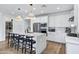 Modern kitchen with white cabinets, an island with seating, and stainless steel appliances at 25422 S 228Th St, Queen Creek, AZ 85142