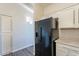 Modern kitchen with black refrigerator and white cabinets at 2727 N Price Rd # 22, Chandler, AZ 85224