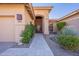 Elegant entryway with a metal door, stone pathway and lush greenery at 29306 N 70Th Way, Scottsdale, AZ 85266