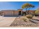 Single-story home with desert landscaping, three-car garage, and neutral color scheme at 29306 N 70Th Way, Scottsdale, AZ 85266