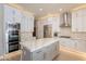 Spacious kitchen featuring a large island and white cabinetry at 29306 N 70Th Way, Scottsdale, AZ 85266