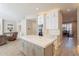 Modern kitchen with a large island and a view of the living area at 29306 N 70Th Way, Scottsdale, AZ 85266