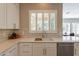 Clean kitchen with white cabinets, quartz countertops, and a farmhouse sink at 29306 N 70Th Way, Scottsdale, AZ 85266