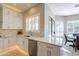 Bright kitchen with white cabinets, quartz countertops, and a view to the dining area at 29306 N 70Th Way, Scottsdale, AZ 85266