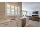 Modern kitchen with white cabinets, quartz countertops, and a view of living room at 29306 N 70Th Way, Scottsdale, AZ 85266