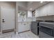 Laundry room with washer, dryer, and white cabinets at 29306 N 70Th Way, Scottsdale, AZ 85266