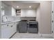 Bright laundry room with modern appliances and cabinets at 29306 N 70Th Way, Scottsdale, AZ 85266