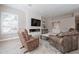 Spacious living room featuring a fireplace and large TV at 29306 N 70Th Way, Scottsdale, AZ 85266