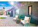 Cozy front porch with brickwork, comfortable seating, and stylish decor, creating a welcoming entrance to the house at 2942 N 81St Pl, Scottsdale, AZ 85251