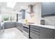 Modern kitchen with gray cabinets, herringbone backsplash, and stainless steel appliances at 2942 N 81St Pl, Scottsdale, AZ 85251