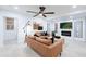 Bright living room with a brown leather sofa, fireplace and large TV at 2942 N 81St Pl, Scottsdale, AZ 85251