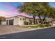 White two-story home with a three car garage and lush landscaping at 3038 E Waterman Way, Gilbert, AZ 85297