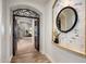 Elegant hallway with arched entryway and decorative wall mirror at 3038 E Waterman Way, Gilbert, AZ 85297