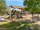 Shaded playground with swings, slides, and play structures at 3038 E Waterman Way, Gilbert, AZ 85297