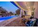 Relaxing covered patio with string lights overlooking the pool at 3038 E Waterman Way, Gilbert, AZ 85297