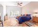 Bright bedroom with a navy blue bedspread, ceiling fan and tiled floor at 3531 E Utopia Rd, Phoenix, AZ 85050