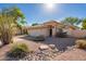 Front yard view of charming one-story house with rock landscaping at 3531 E Utopia Rd, Phoenix, AZ 85050