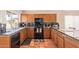 L-shaped kitchen with granite countertops and dark wood cabinets at 3531 E Utopia Rd, Phoenix, AZ 85050