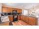 L-shaped kitchen with granite countertops and dark wood cabinets at 3531 E Utopia Rd, Phoenix, AZ 85050