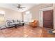 Bright living room with tiled floors, gray sofa, and orange accent chair at 3531 E Utopia Rd, Phoenix, AZ 85050