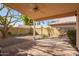 Covered patio with a ceiling fan and gravel backyard at 3531 E Utopia Rd, Phoenix, AZ 85050