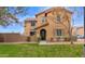 Tan two-story house with landscaping and walkway at 3667 E Angstead Ct, Gilbert, AZ 85296