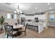 Eat-in kitchen with island, white cabinets, and granite counters at 3667 E Angstead Ct, Gilbert, AZ 85296