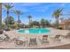 Community pool with lounge chairs and palm trees at 3667 E Angstead Ct, Gilbert, AZ 85296