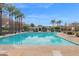 Inviting community pool with surrounding lounge chairs and palm trees at 3667 E Angstead Ct, Gilbert, AZ 85296