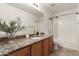 Bathroom with granite countertop, wood cabinets, and shower/tub at 3675 E Parkview Dr, Gilbert, AZ 85295