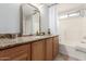 Bathroom with granite countertop, wood cabinets, and bathtub at 3675 E Parkview Dr, Gilbert, AZ 85295