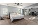 Spacious bedroom with large bed, built-in shelving, and walk-in closet at 3675 E Parkview Dr, Gilbert, AZ 85295