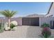 Landscaped backyard with drought-tolerant plants and a secure gate at 39012 N 6Th Dr, Phoenix, AZ 85086