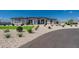 Modern house exterior with a landscaped front yard and driveway at 39027 N 6Th Dr, Phoenix, AZ 85086